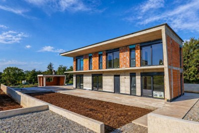 A modern villa with a swimming pool and a spacious garden - under construction
