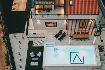 A house with a swimming pool in a quiet environment