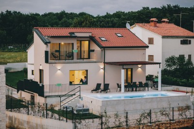 A house with a swimming pool in a quiet environment