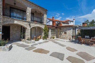 Stone house in a row with three apartments