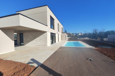 A modern villa with a pool in a new building 3